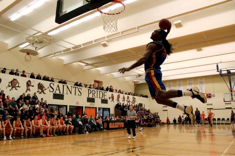 Damon Powell of the Harlem Crowns puts his slam dunk abilities on display during the Crowns fundraiser game against the St. Paul Regional Saints last weekend.