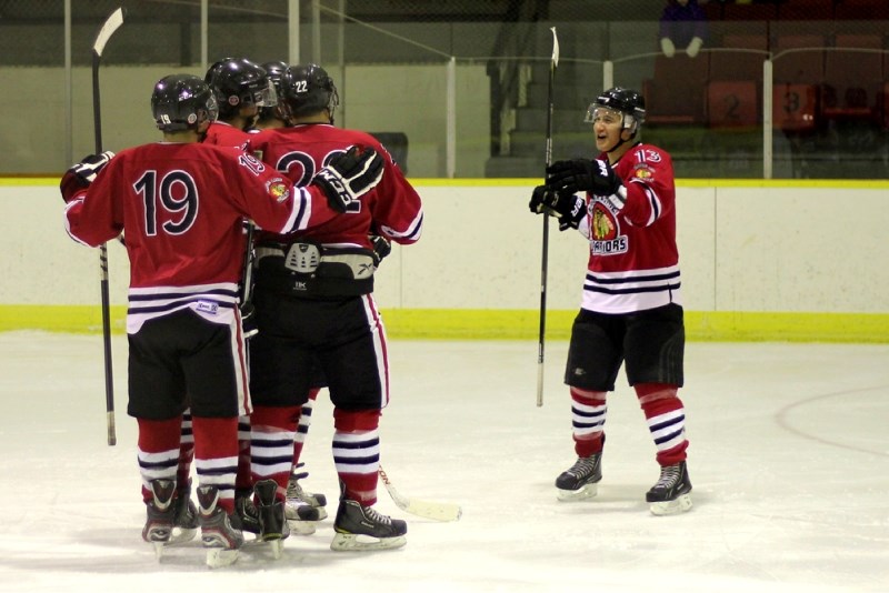 Dallas Desjarlais jumps in on a Saddle Lake goal celebration during the Warriors 11-4 victory over the St. Paul Canadiens last Friday evening.