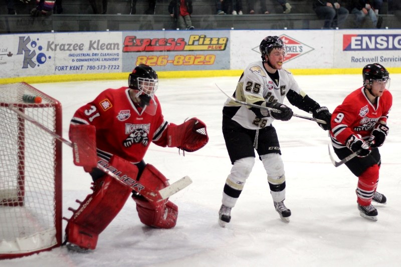 Bonnyville Pontiacs captain Locke Muller tries to create some traffic in front of Whitecourt Wolverines goaltender Tanner Kovacs during the Pontiacs series-tying Game 2 loss