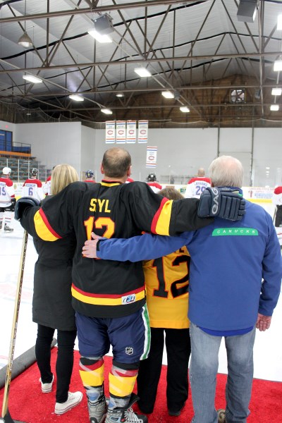 The legenday Stan &#8220;Steamer&#8221; Smyl watches alongside his father, Bernard, his mother, Pauline, and his daughter, Jillian, as his name is raised to the rafters of