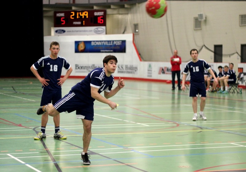 école Mallaig Stinger Austin Smyl (left) and CLaude Dargis (right) watch as Marcel Feland fires a penalty shot on goal during the Singers 32-8 zone finals victory over BCHS.