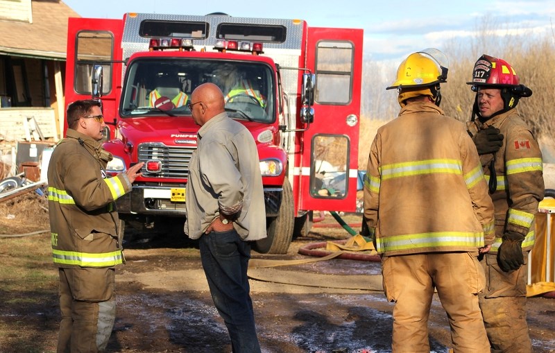 St. Paul Fire Chief Trevor Kotowich (left) speaks to Art Gratton of the Mallaig Fire Department, at a call out near McRae on Friday. Ashmont and Mallaig fire departments also 