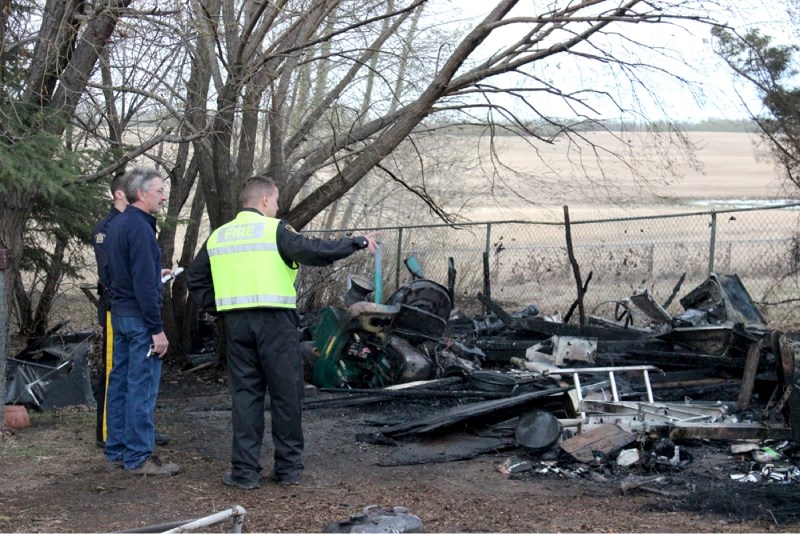 St. Paul Fire Chief Trevor Kotowich speaks with a Lafond resident after an unattended fire pit led to a near-catastrophic blaze.