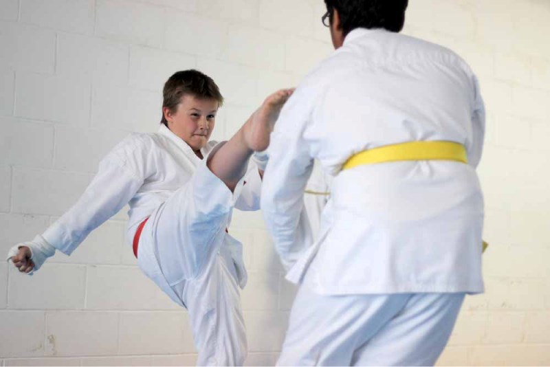 James Kozicki throws a kick at Ehab Bajwa during the St. Paul Karate-Do Mini-Tournament last Monday.