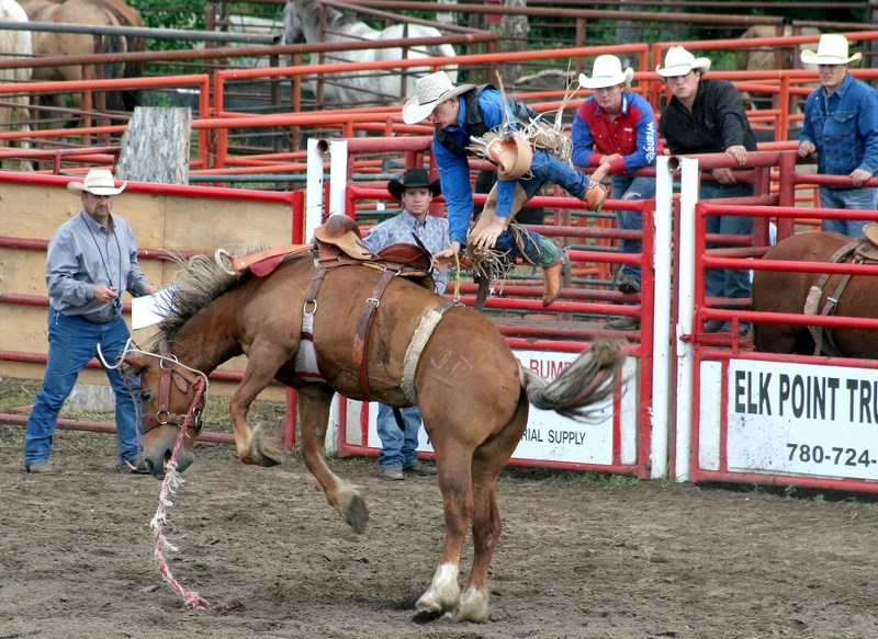 Jake Vernon is thrown from a horse, while participating in the saddle bronc event at the Stoney Lake Stampede, July 7.