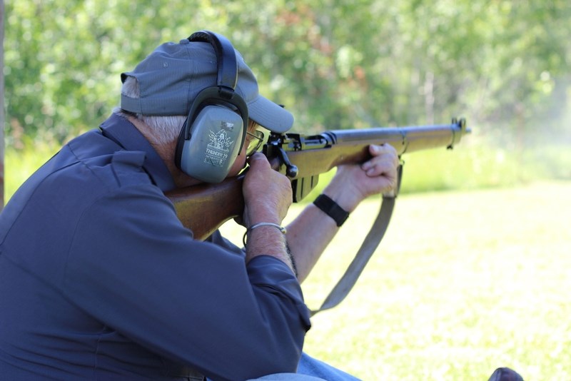 Rollie Inman takes aim and fires a bullet through the bullseye at the .303 British Rifle Shoot at the St. Paul Fish and Game Association Shooting Range on Saturday afternoon. 
