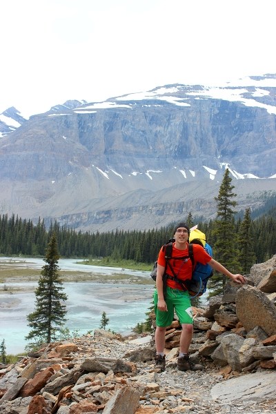 Reporter Ryan McCracken traverses across a steep rocky incline en route to Berg Lake at Mount Robson provincial park in British Columbia.