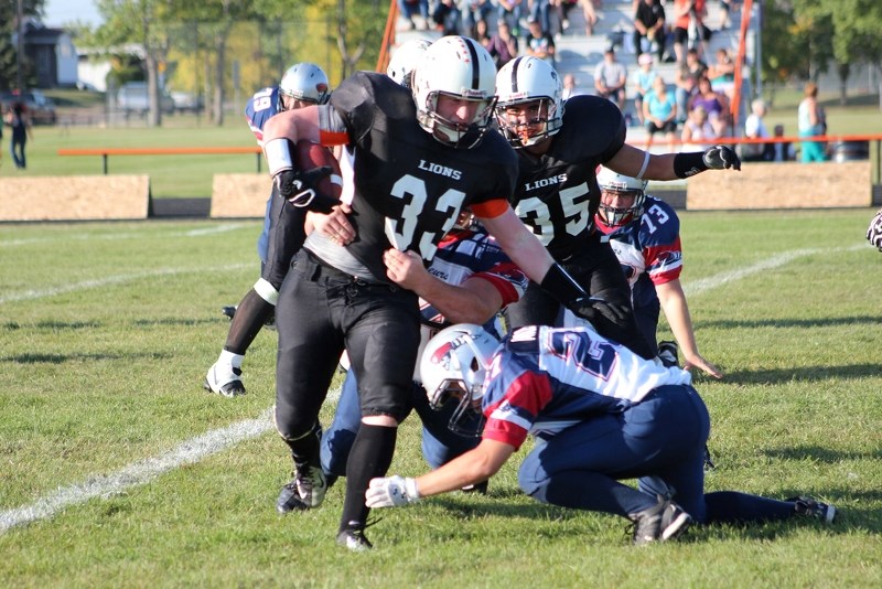 Dylon Machura breaks off a pair of tackles and moves the ball upfield during the Lions 38-0 victory over the Bonnyville Voyageurs on Friday.
