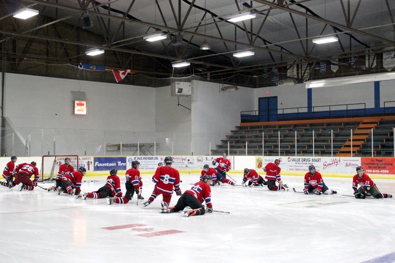 A number of St. Paul Canadiens skaters stretch it out before the red versus white game at Canadiens training camp on Sunday.