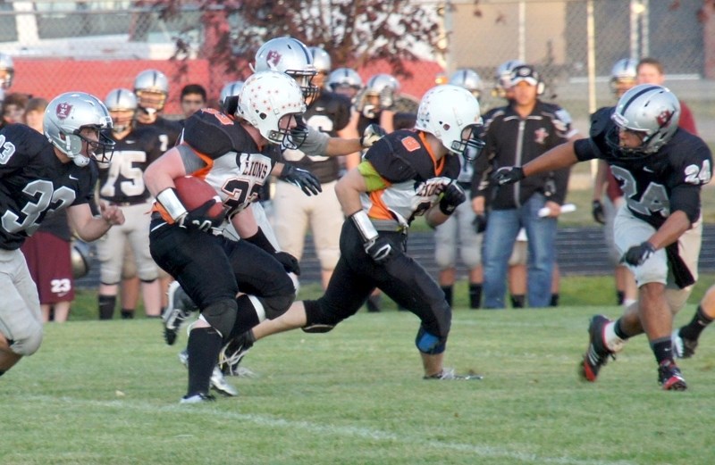 Dylon Machura turns to move the ball upfield during the St. Paul Lions 27-2 victory over the Lloydminster Holy Rosary Raiders on Friday.