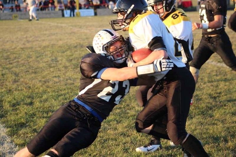 Dave Thomson lays a big hit on a Cold Lake Royals ball carrier in the St. Paul Lions 36-29 victory on Friday night.