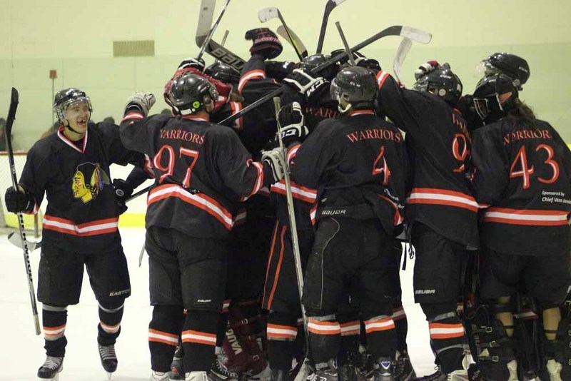The Saddle Lake Warriors celebrate their second straight victory to start off the 2013-14 NEAJBHL season on Saturday.