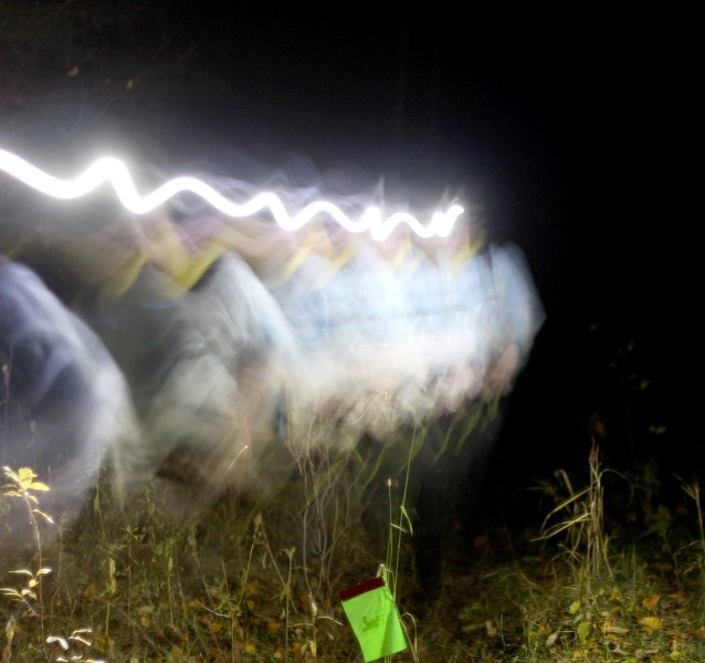 Adam French traverses through the bush on leg eight of the Iron Horse Ultra 100 mile solo run, near St. Eduoard at around 12:45 a.m. on Sunday morning.