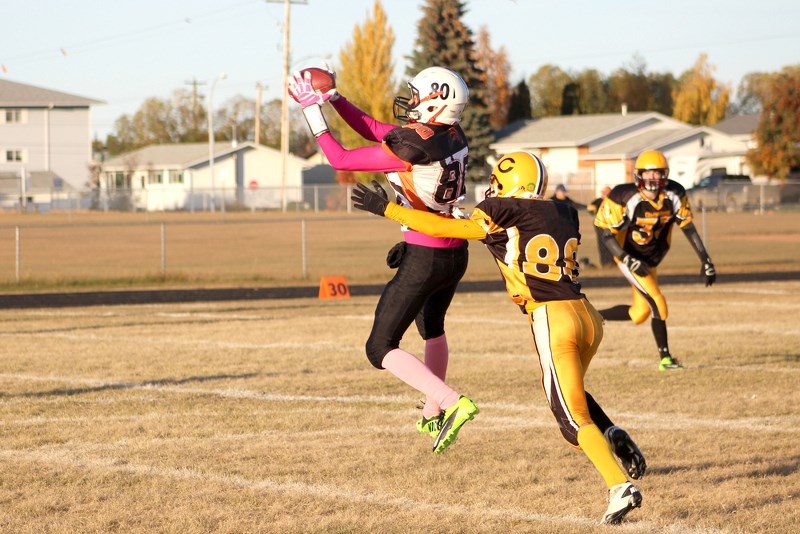 Lions wide receiver Brian Boucher goes up to make the catch during the Lions&#8217; 55-23 victory over the Wainwright Commandos last Thursday at St. Paul Regional.