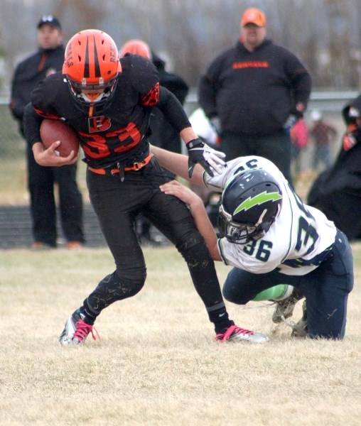 St. Paul Bengals quarterback Madison Brousseau shakes off a Lloydminster Chargers defender in the Bengals 44-6 loss on Saturday.