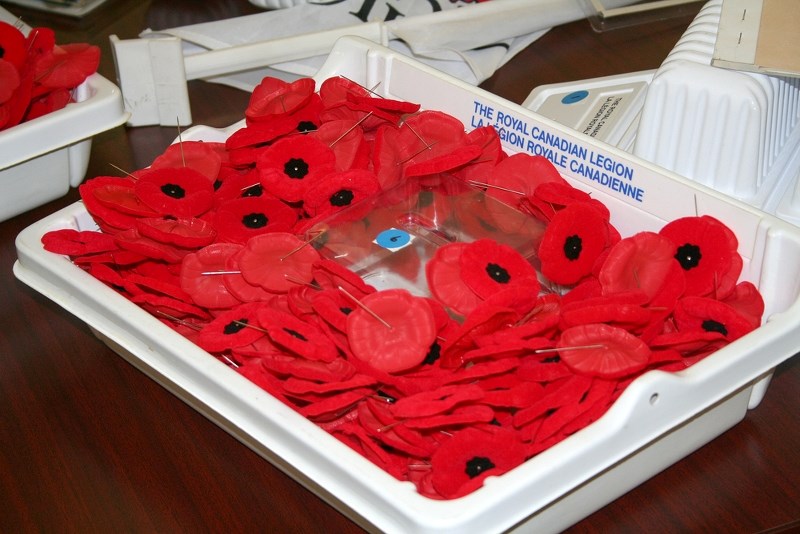 Royal Canadian Legion members gathered On Oct. 25, to mark the beginning of the poppy campaign at the Legion building on 49 Ave. by raising a poppy flag and preparing poppy trays to be distributed to businesses around town.
