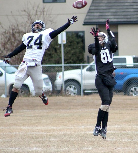 Lions&#8217; wide receiver Darrell Stranger leaps to make a touchdown grab over Raiders&#8217; safety Donivan Grannum. The toucdown put the Lions ahead 34-10, en route to a