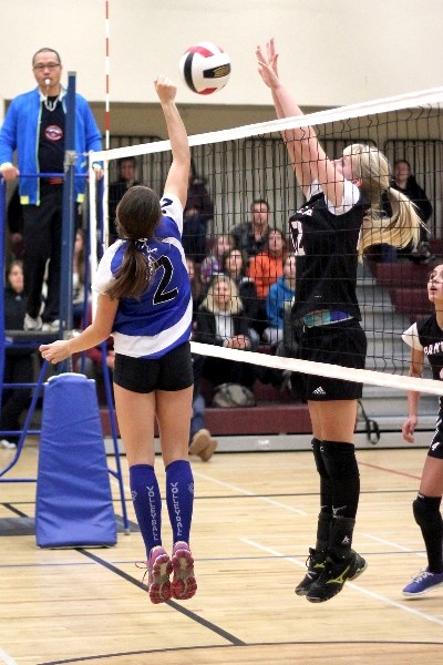 Glen Avon Panthers captain Emilee Smid (right) goes up to block a shot from a Racette Raider in Thursday night&#8217;s Jr. SPAA championship match.