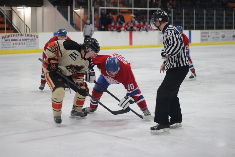 St. Paul Canadiens centre Pierre Beaudoin fights for the puck with Wainwright Bisons centre Rylan Mauws during a January match up. The Habs and Bisons will square off in the