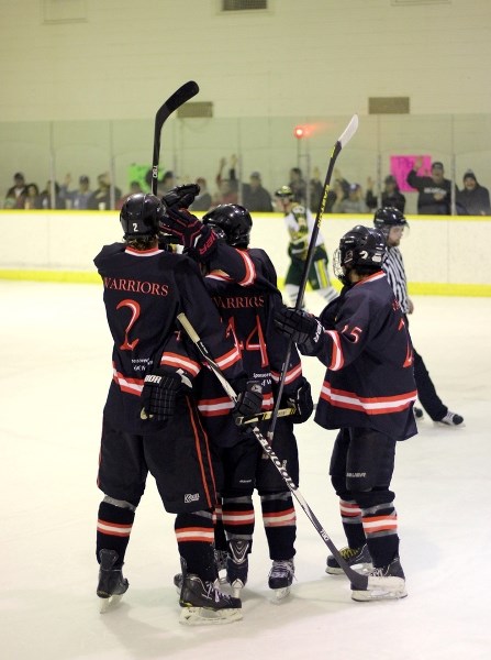 The Saddle Lake Warriors celebrate scoring a pivotal goal in the third of their series-clinching 8-5 victory over the Killam Wheat Kings at Manitou Kihew Arena on Feb. 19.