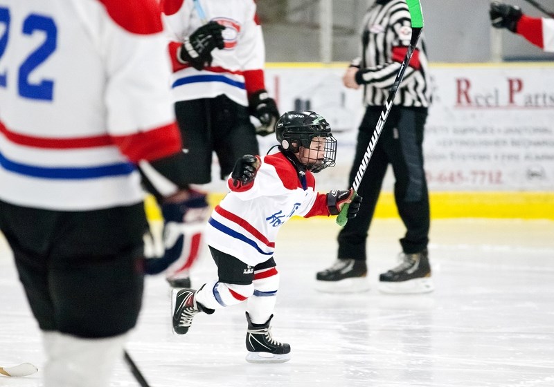 Timbit hockey player Wade Howse celebrates a goal surrounded by midget players, during the Timbits Future All-Star Game on March 14 at Clancy Richard Arena.