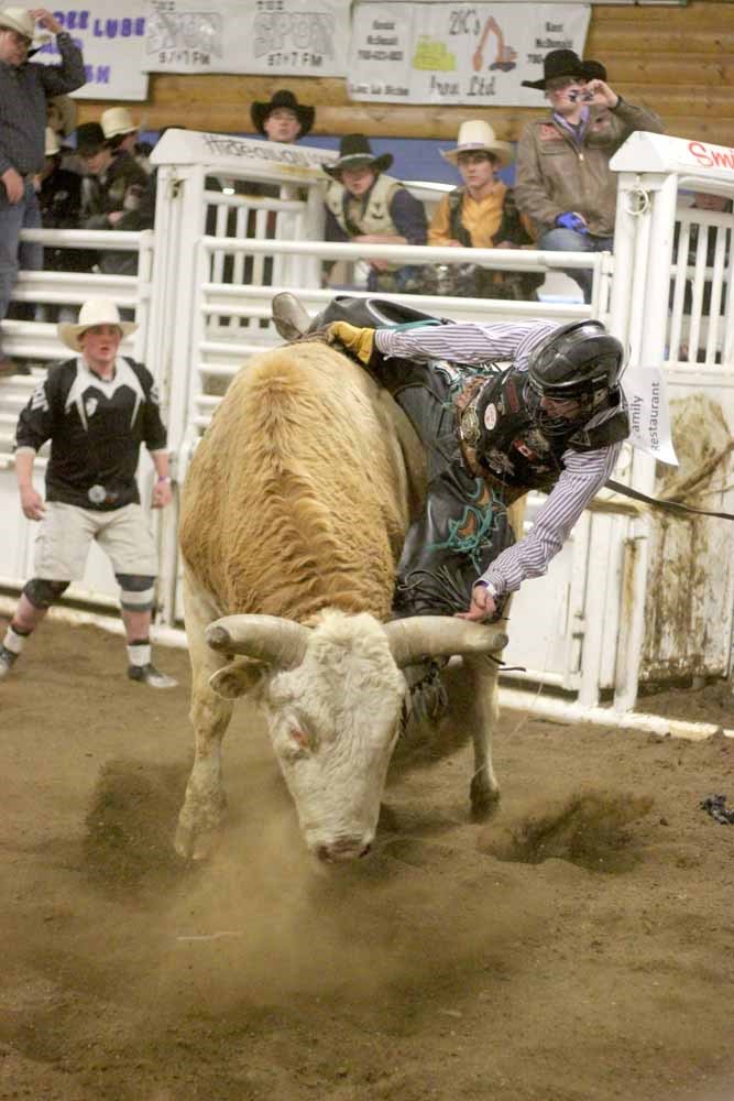 Michael Ostashek of Vermilion tries to stay on top of Punky the bull at Bull-A-Rama 2014, held at the St. paul Ag. Corral on Saturday evening.
