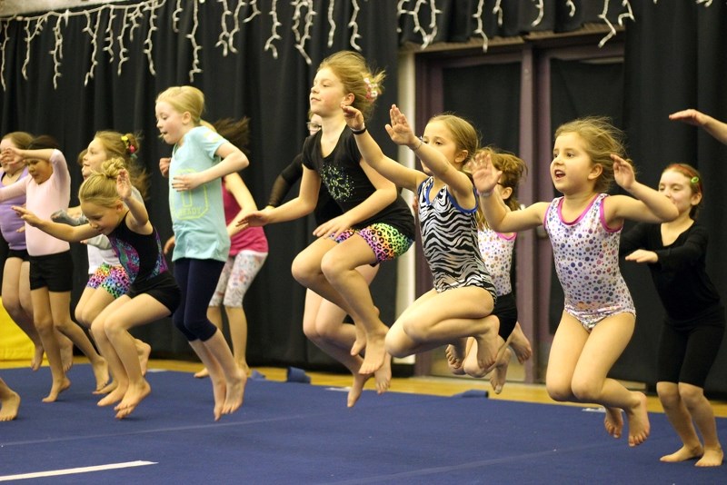 Jadyn Dunlop, Lexis Ouellette, Ashlynn Trefenanko, Courtney Smyl and Sara Smyl leap into the air during a game of &#8216;What time is it Mr. Wolf&#8217; at the final session