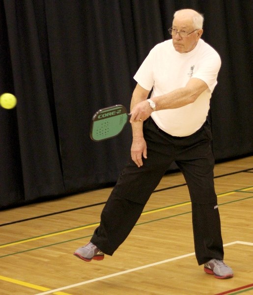 Chuck Ouellette returns a shot during a game of pickle-ball at the ECFER gymnasium on March 31.