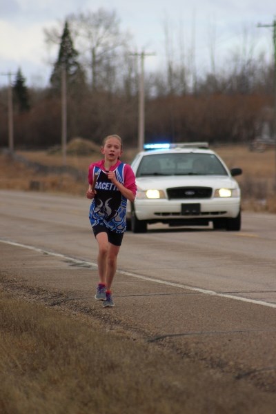 Racette&#8217;s Abigail Zieverink pushes herself through a cold, windy run down Highway 28 for the RCMP Road Race on May 6.
