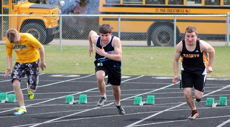 (From left) Jonah Crocker, Patrick Dion and Liam Krys explode off the blocks for the 100 m dash at the St. Paul Athletics Association senior track and field finals at St.