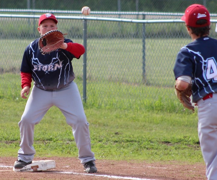 St. Paul peewee Storm first baseman Tarron Smith records an out during the team&#8217;s championship game against the Elk Point Sox in Elizabeth Settlement on Saturday