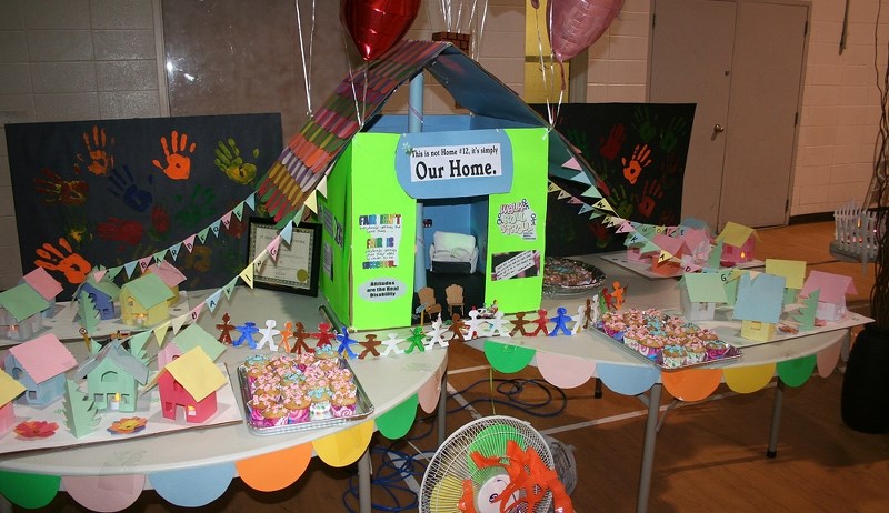 A number of displays were set up in the SPAN gymnasium, including ones featuring collages devoted to the various residences associated with SPAN, in the community.