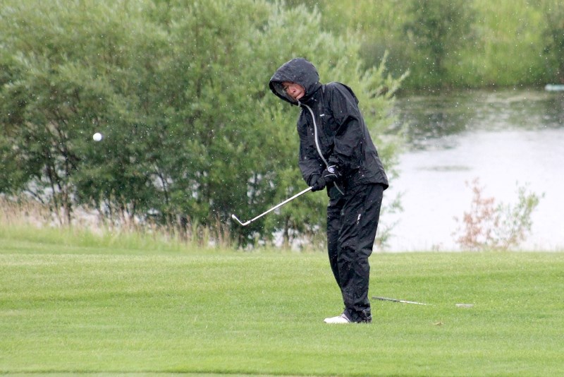 Cameron Moyah takes an approach shot onto the 18th green at the St. Paul Golf Club&#8217;s Men&#8217;s Open on Sunday.