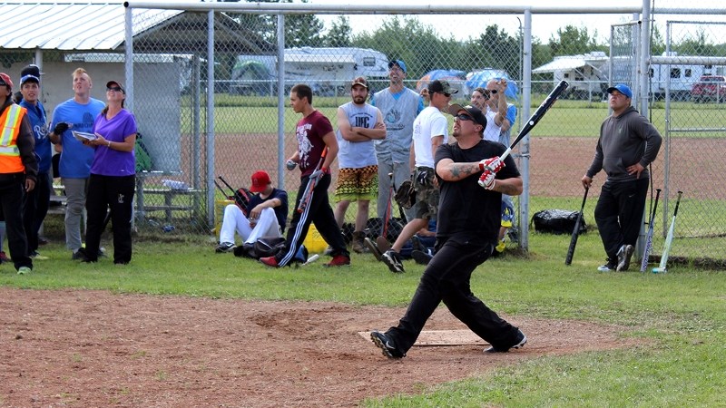 Scott Jeffrey, champion of the men&#8217;s home run derby that took place in Ashmont on Aug. 9, admires a deep shot along with the rest of the crowd.