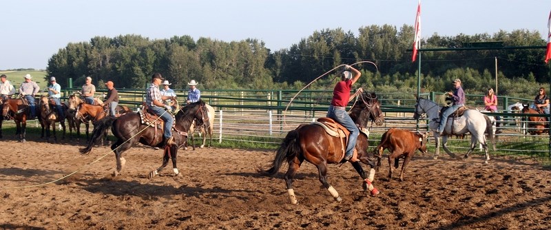 Vince Strezepek (left), and Dillon Graham close in on a calf at a roping jackpot held to raise funds for Malcolm &#8220;Mouse&#8221; McKenzie on Aug. 7.