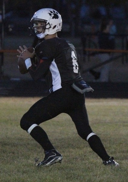 Lions quarterback Patrick Dion sets up to throw during Friday night football action in St. Paul on Sept. 19.