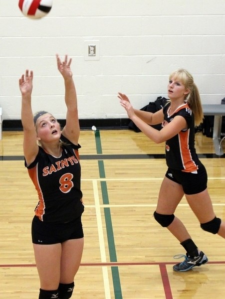 Raylene Allan sets the ball for Emilee Smid, who&#8217;s getting ready for the hit.