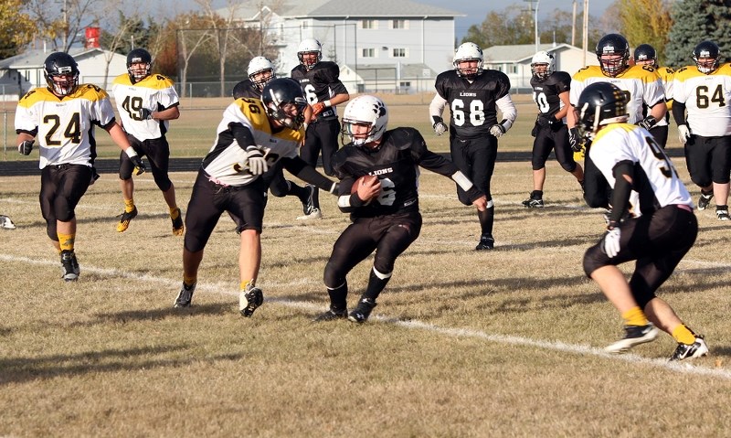 Lions quarterback Patrick Dion tucks the ball and uses his legs to gain a few yards.
