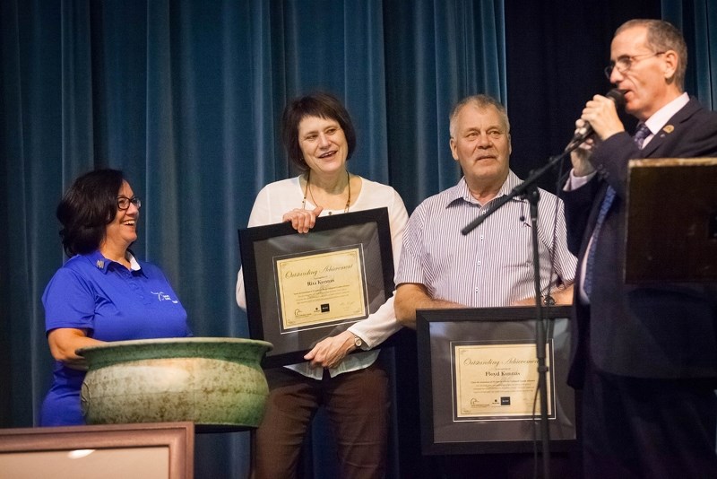 Rita and Floyd Kunnas (centre) accept 25-year plaques from Ducks Unlimited representative Dale Scott and St. Paul committee chair Carol Anne MacNeil.