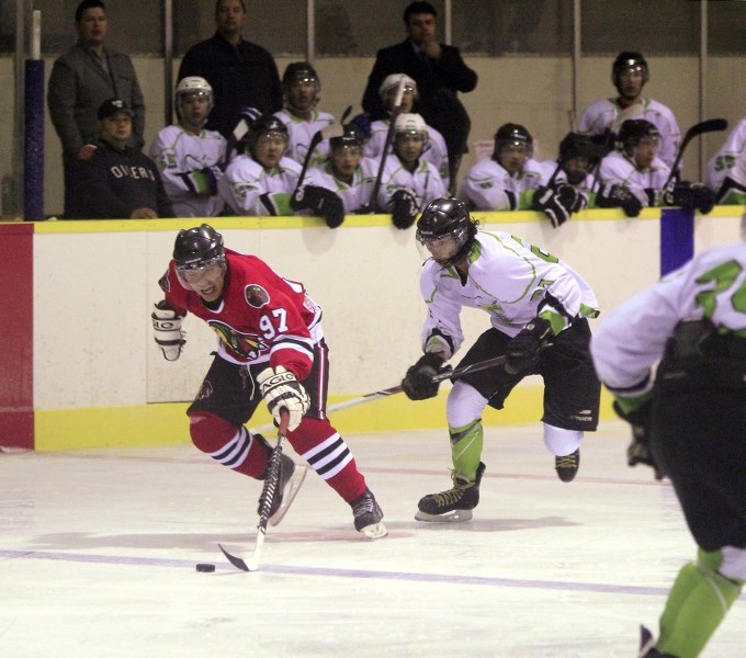The Warriors&#8217; Lyndon Bird brings the puck over the blue line with a Frog Lake defender in hot pursuit.