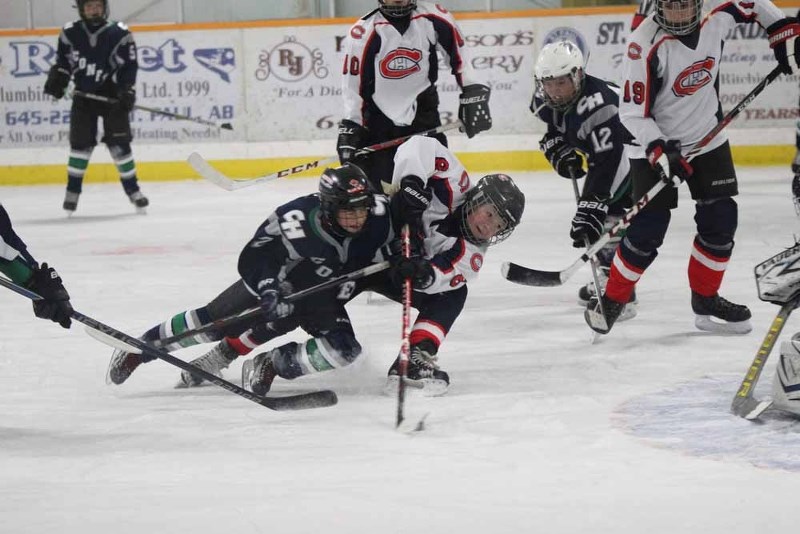 Canadiens&#8217; player Logan Gratton attempts a backhand shot in traffic during the tournament.