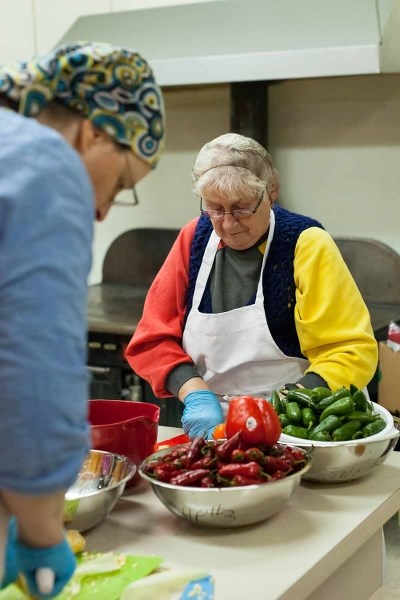Maria Barrier sets to work on chopping vegetables as part of the Second Harvest project, which distributes food to people in need in the community.