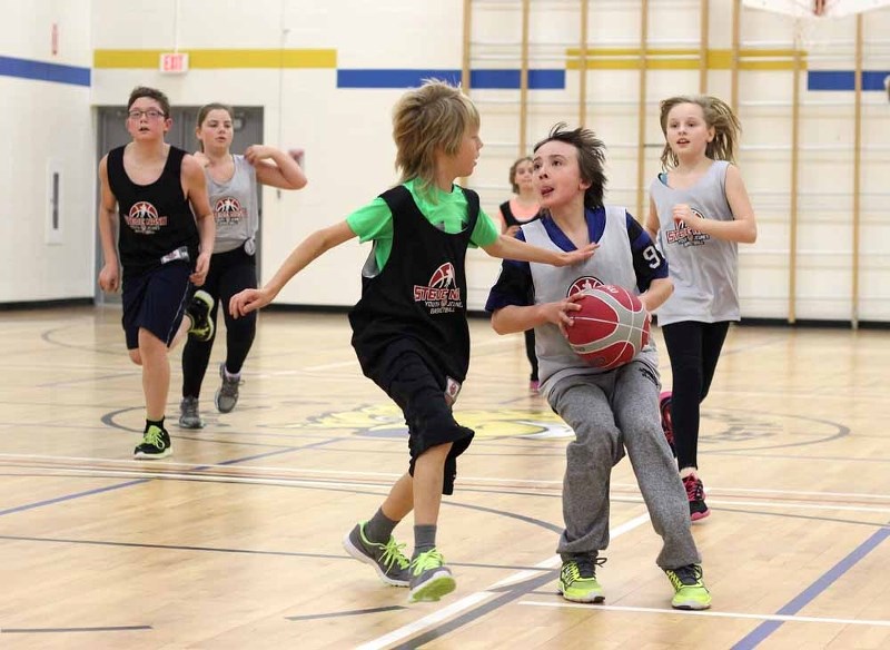 Jayden Joly takes a shot, while Brayden Rivard attempts to block it, in a basketball game last week that featured elementary students who had participated in a development
