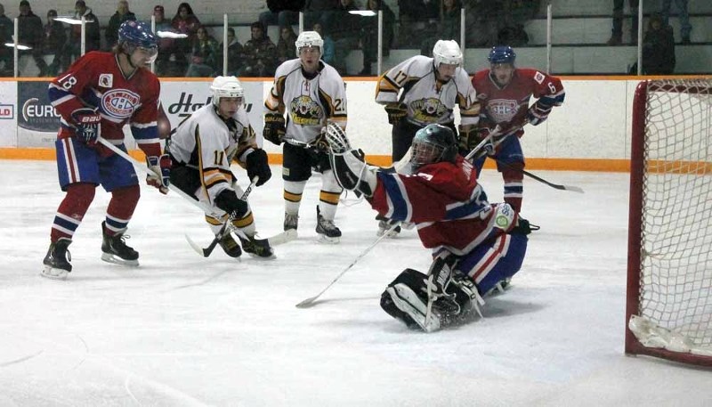 Canadiens&#8217; goalie Brady Jewan stops a puck while his teammate Kris Trach offers support during a Nov. 28 game in Elk Point against the Vermilion Tigers..