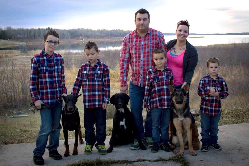 Ashley Kennedy and her partner Stephane Lamoureux stand alongside (left to right) Austyn, Karsyn, Landyn, Ryland and their family pets. The family is one of five local