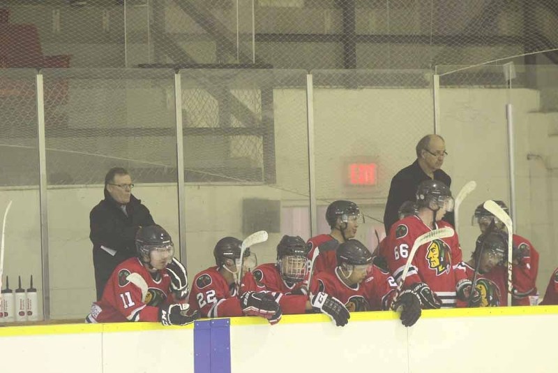 New coaches Clint Trimble (left) and Terry Ewasiuk kept watch of the ice as the Warriors took on the Wheat Kings Dec. 7.