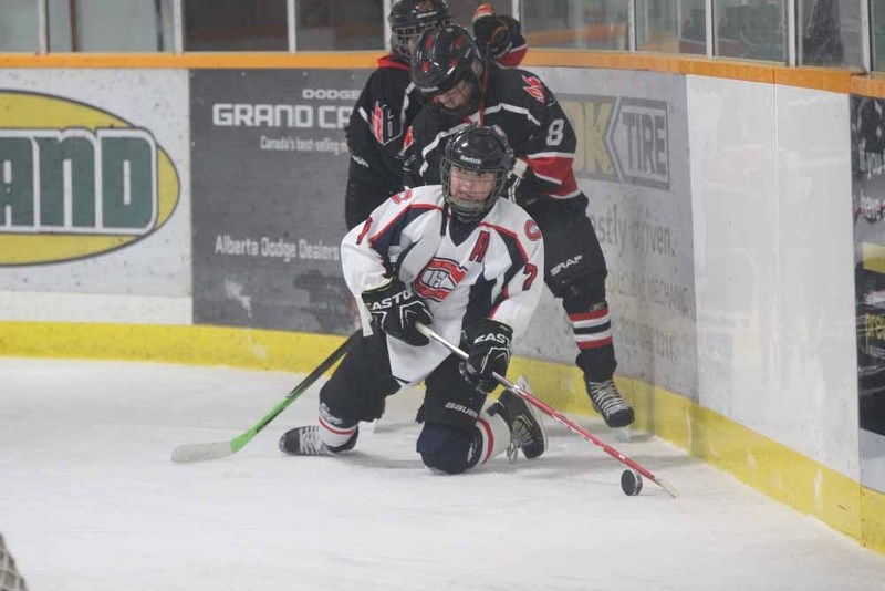 St. Paul&#8217;s Jayden Joly plays the puck off the boards during the Atom A tournament in St. Paul on Dec. 13.
