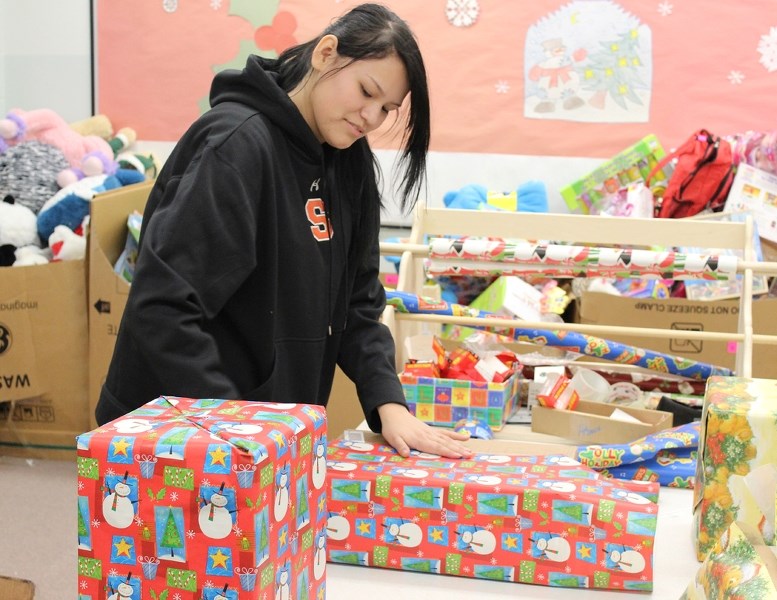 Students from St. Paul Regional helped wrap gifts for the Santa&#8217;s Elves program in mid-December. Just before Christmas, the elves joined forces with the Knights of