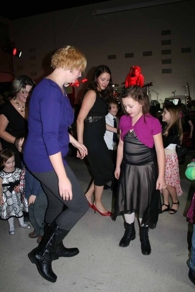 Tamie Gratton and her daughter Kylin were having a ball at the New Year&#8217;s Eve Family Benefit event on Dec. 31 at the Recreation Centre, as the Retro Rockets performed.