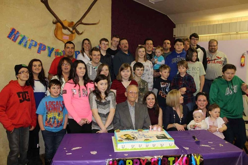 Elliott poses with a swarm of grandchildren and great-grandchildren during his 100th birthday party on Jan. 24.